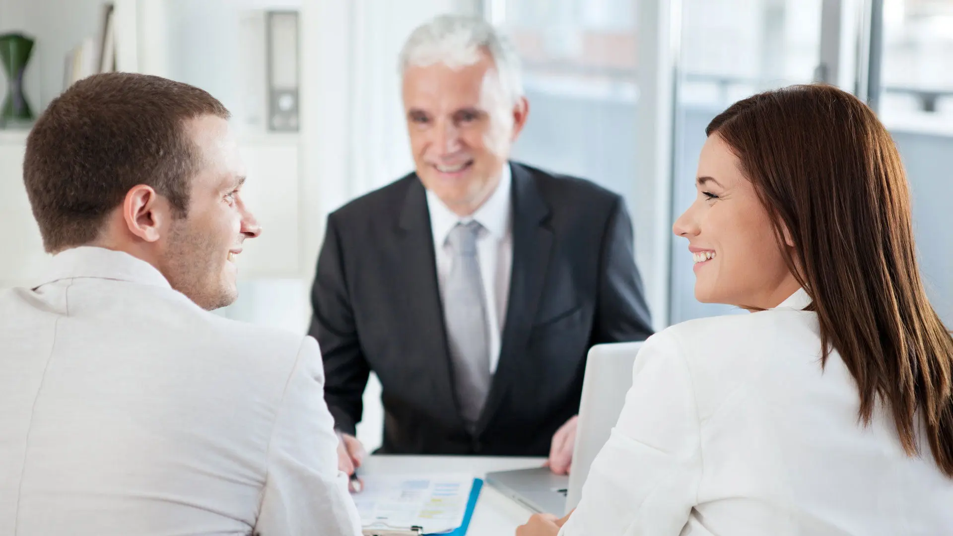 A married couple with their financial advisor.