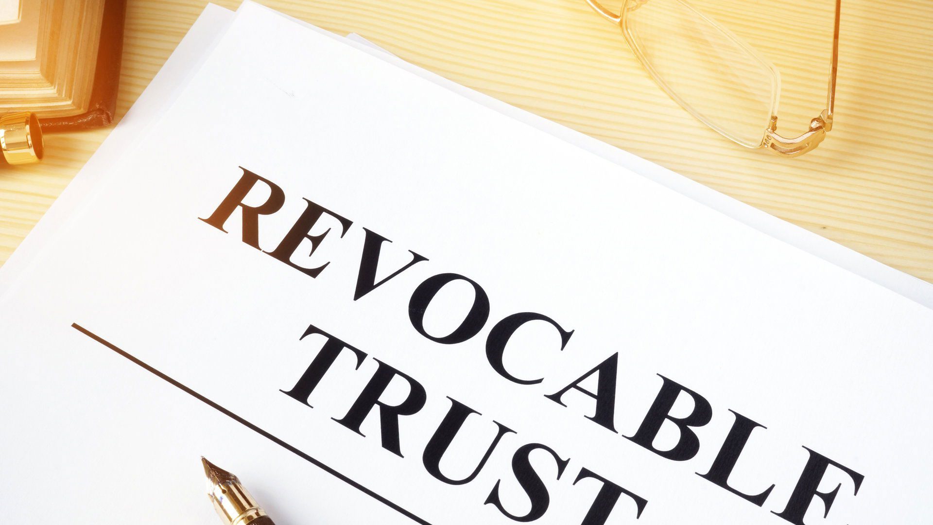 Revocable trust on a wooden desk.